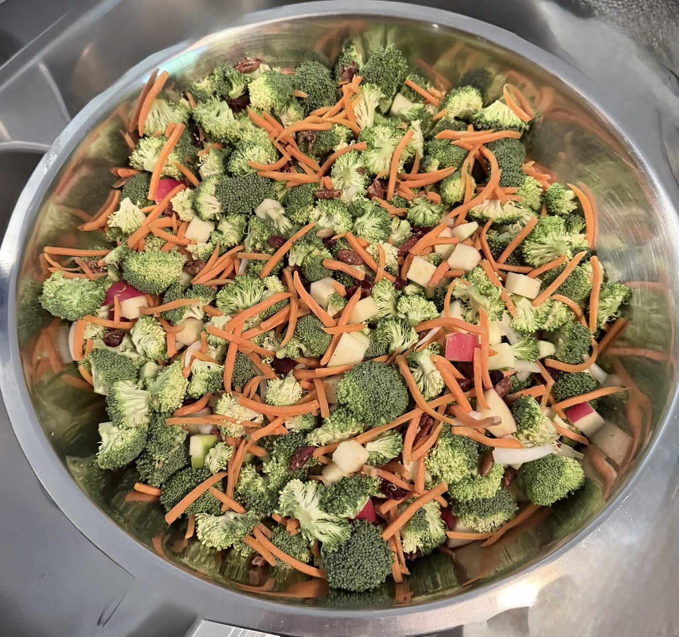 Broccoli apple slaw side dish in a serving bowl