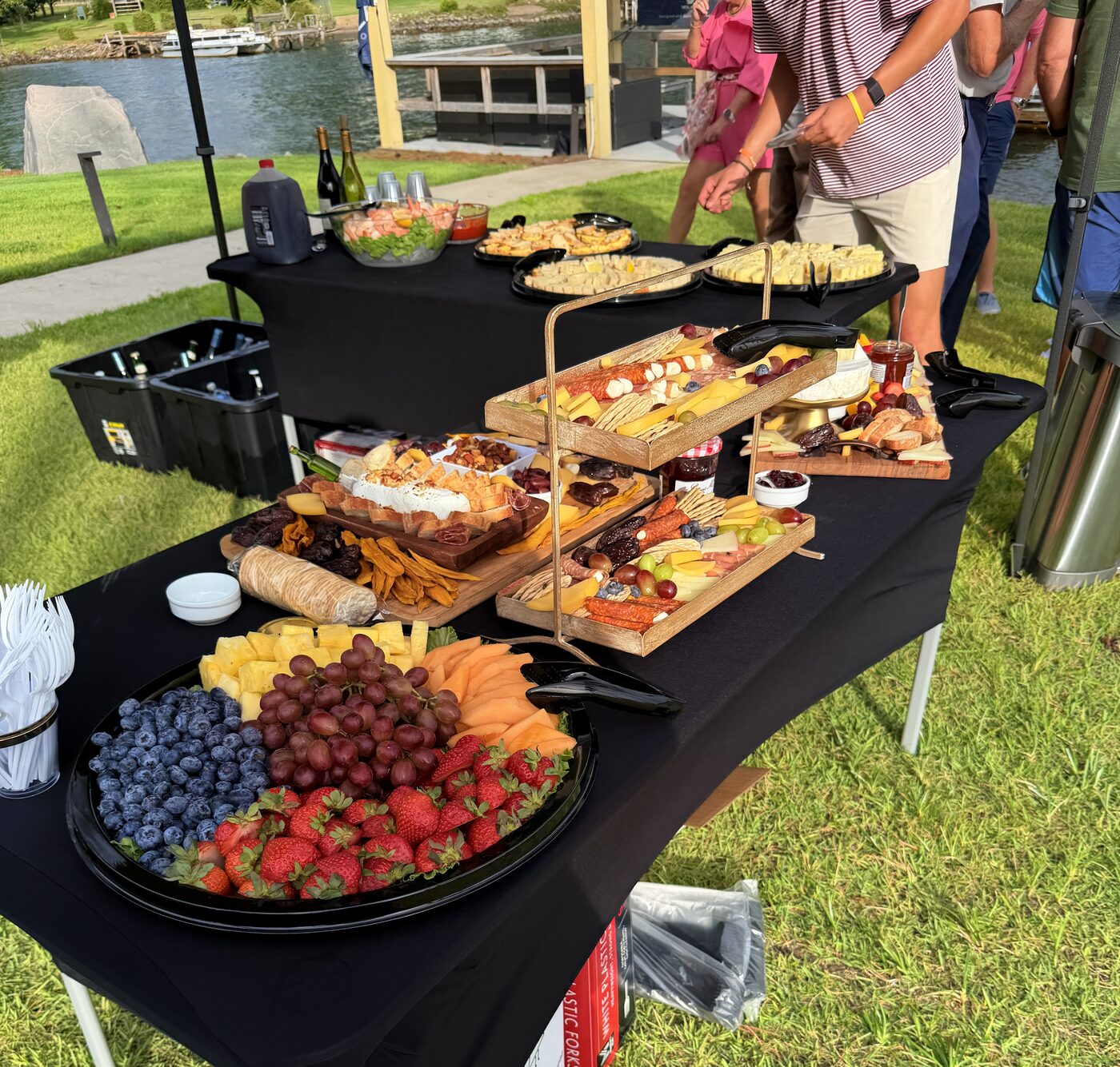 Lakefront event buffet with charcuterie boards and fruit tray catered on Lake Murray
